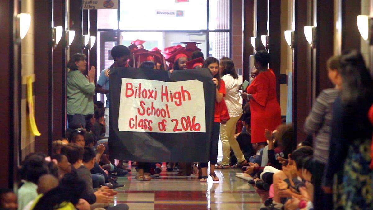 TIM ISBELL/SUN HERALD 
 Seniors of the class of 2016 march through the hallway of Gorenflo Elementary, Tuesday, May 17, 2016. Many of the seniors were former students of Gorenflo.