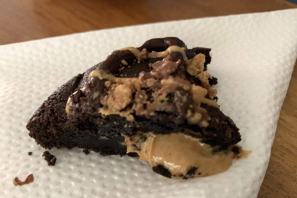 Peanut butter oozes from the center of the PB Overload cookie at Dirty Dough in Biloxi.