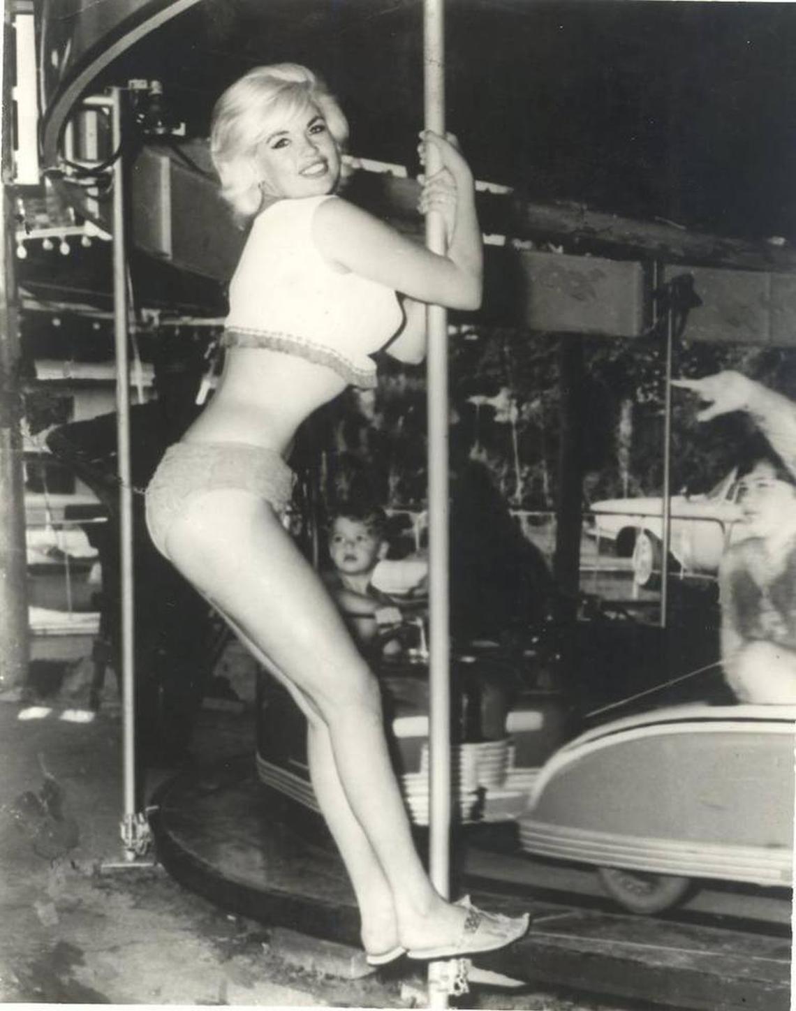 Actress Jayne Mansfield poses on a tiny car merry-go-round in Biloxi while her children enjoy a ride beside the beach. Pascagoula photographer Wallace Reeves, who shot the picture, said it was the last posed photo taken before she was killed in the early hours June 29, 1967, in a traffic accident.