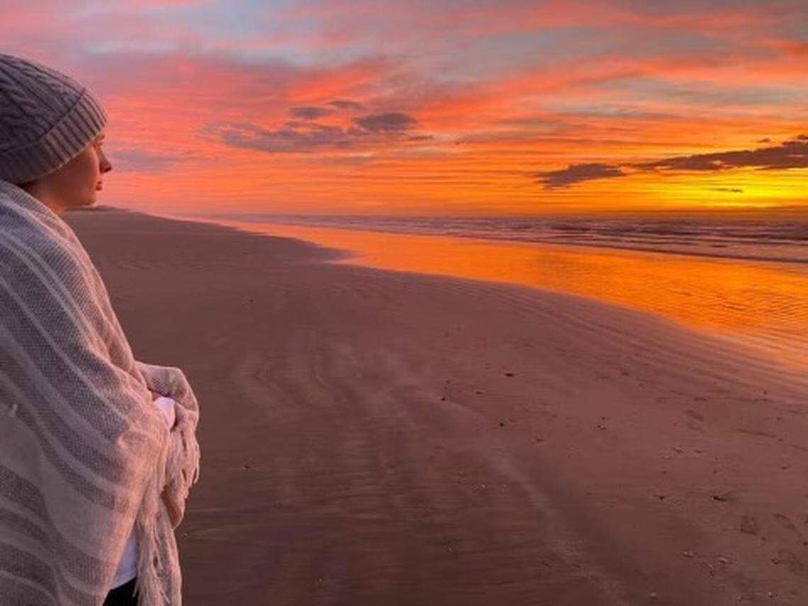 Pass Christian High School graduate Amy Bosarge watches the sunset on the beach in Galveston, where staff and students gathered for her graduation ceremony. Abby, 18, is under hospice care at Texas Children’s Hospital and was too sick to travel home.