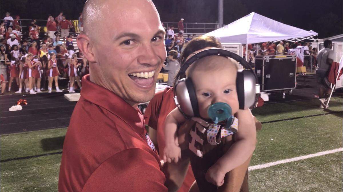 Biloxi coach Katlan French celebrates with his 2 1/2-month old daughter, Swayze, after winning 21-14 at D’Iberville Friday night in the region opener for both teams.