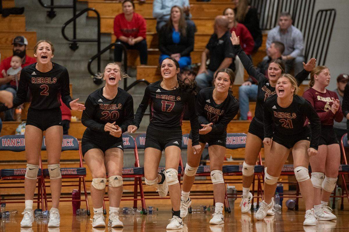 The George County Rebels volleyball team celebrates after a point during the 6A South State Championship game at Hancock High School in Kiln on Monday, Oct. 16, 2023.