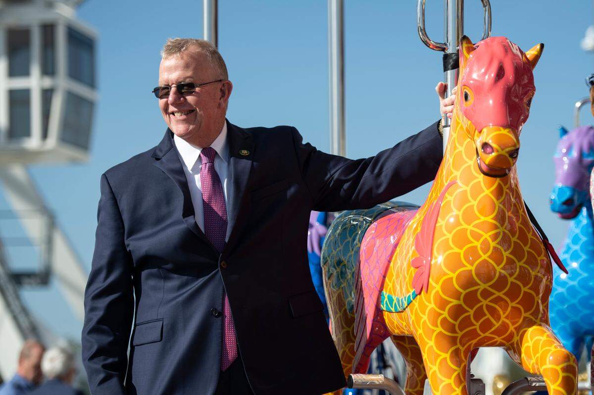 U.S. Rep. Mike Ezell rides on double-decker merry-go-round during the grand opening of Paradise Pier at Margaritaville in Biloxi on Friday, March 3, 2023.