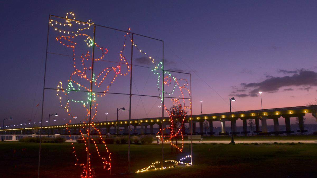 TIM ISBELL/SUN HERALDA lighted display of a reindeer catching a fish is on the grounds at Point Cadet in front of the Maritime and Seafood Industry Museum in Biloxi. 