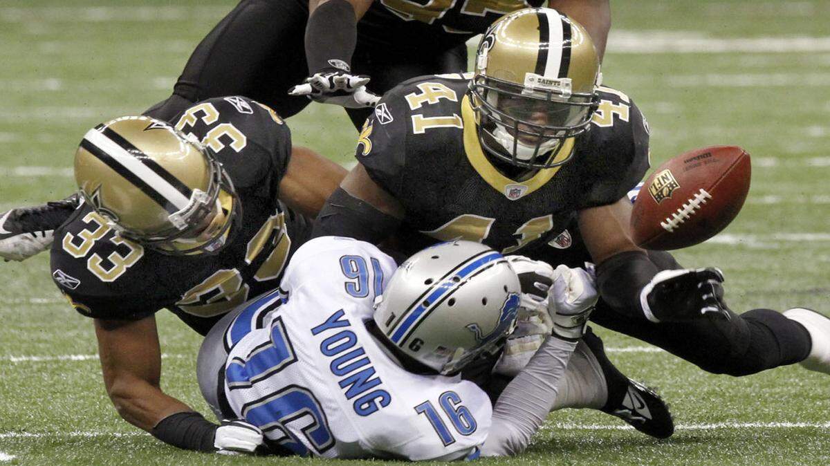 TIM ISBELL/SUN HERALD 
 Saints cornerback Jabari Greer and strong safety Roman Harper combine to knock the ball from Lions receiver Titus Young. Roman Harper will be rejoining the New Orleans Saints after two years with the Carolina Panthers.