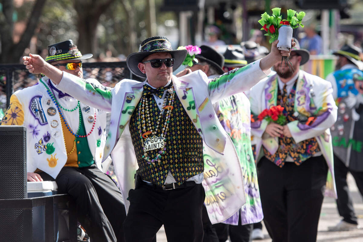 A member of the Selucrey Sophistocats marches during the Ocean Springs Elks Club Mardi Gras Parade in Ocean Springs on Saturday, Feb. 15, 2025.