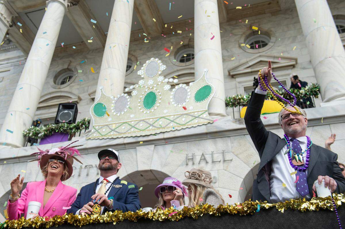 Parade watchers cheer for beads and other throws outside City Hall during the Gulf Coast Carnival Association Mardi Gras parade in Biloxi on Tuesday, March 4, 2025.
