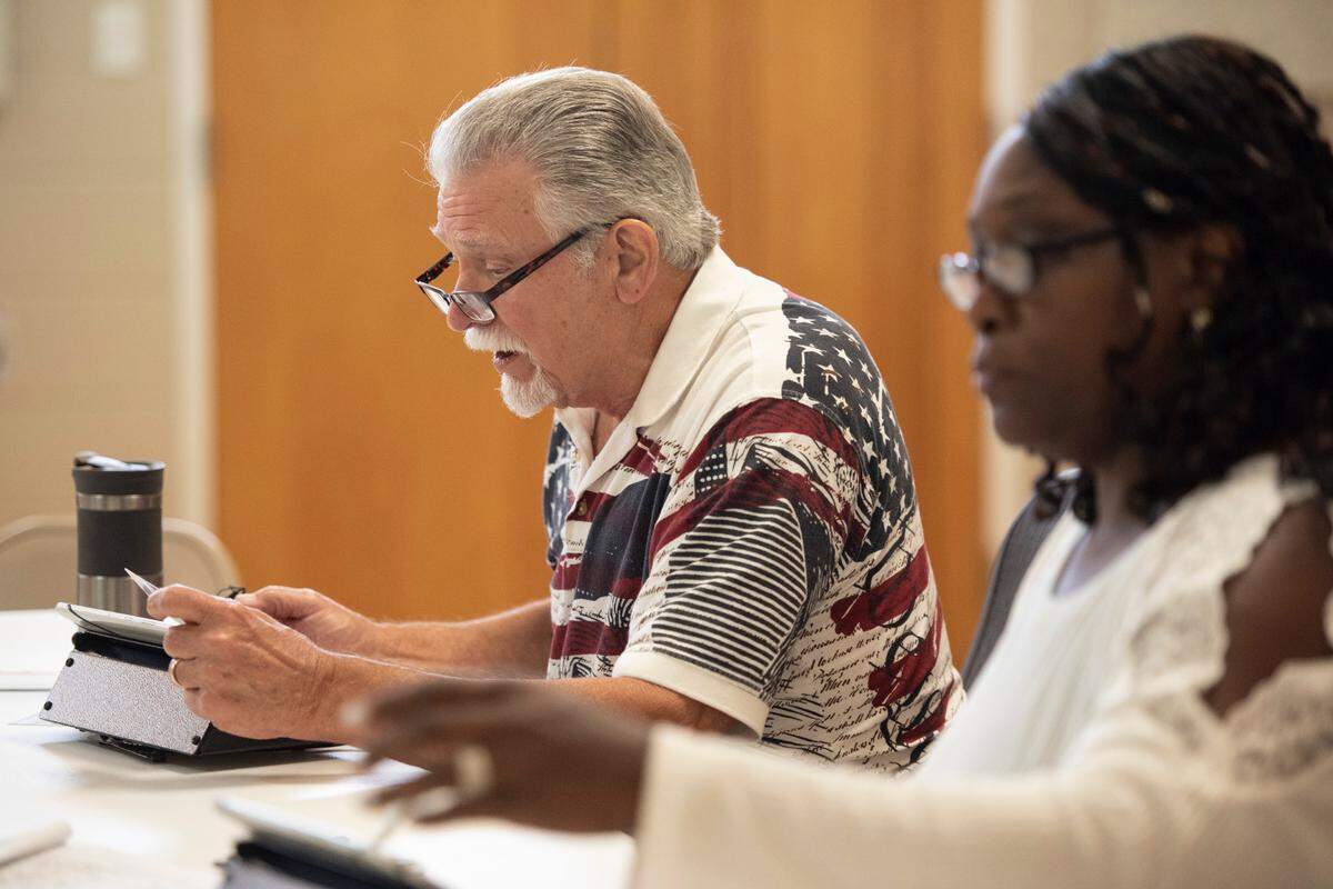 Election workers check in voters as they arrive to vote in the Mississippi primary election at St. Martin Community Center in St. Martin on Tuesday, June 7, 2022.