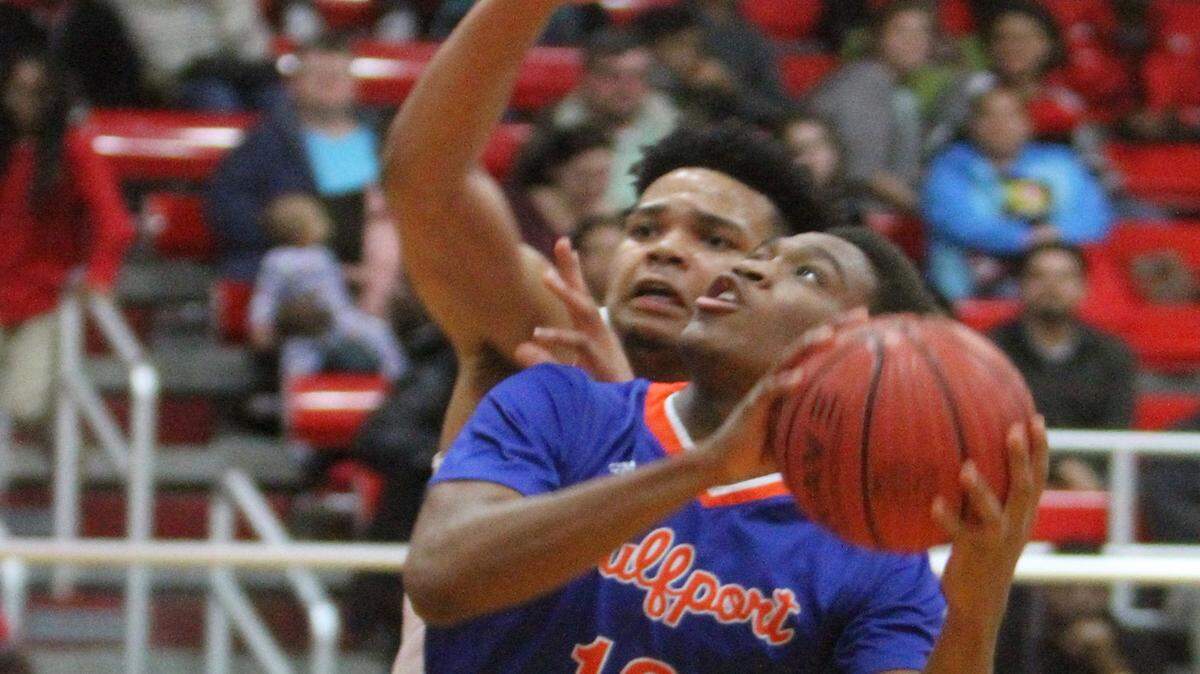 JOHN FITZHUGH/SUN HERALD 
 Gulfport's Alton Conerly drives to the basket against Biloxi's Fred Ramsey-Thompson during the first half of their game at Biloxi on Friday Jan. 22, 2015.