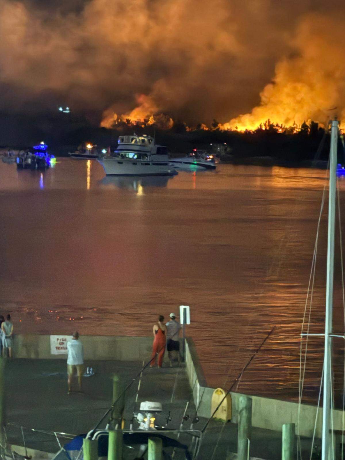 From the deck at McElroy’s Harbor House in Biloxi, Biloxi Fore Department vessels can be seen Friday night heading to Deer Island to fight a fire.