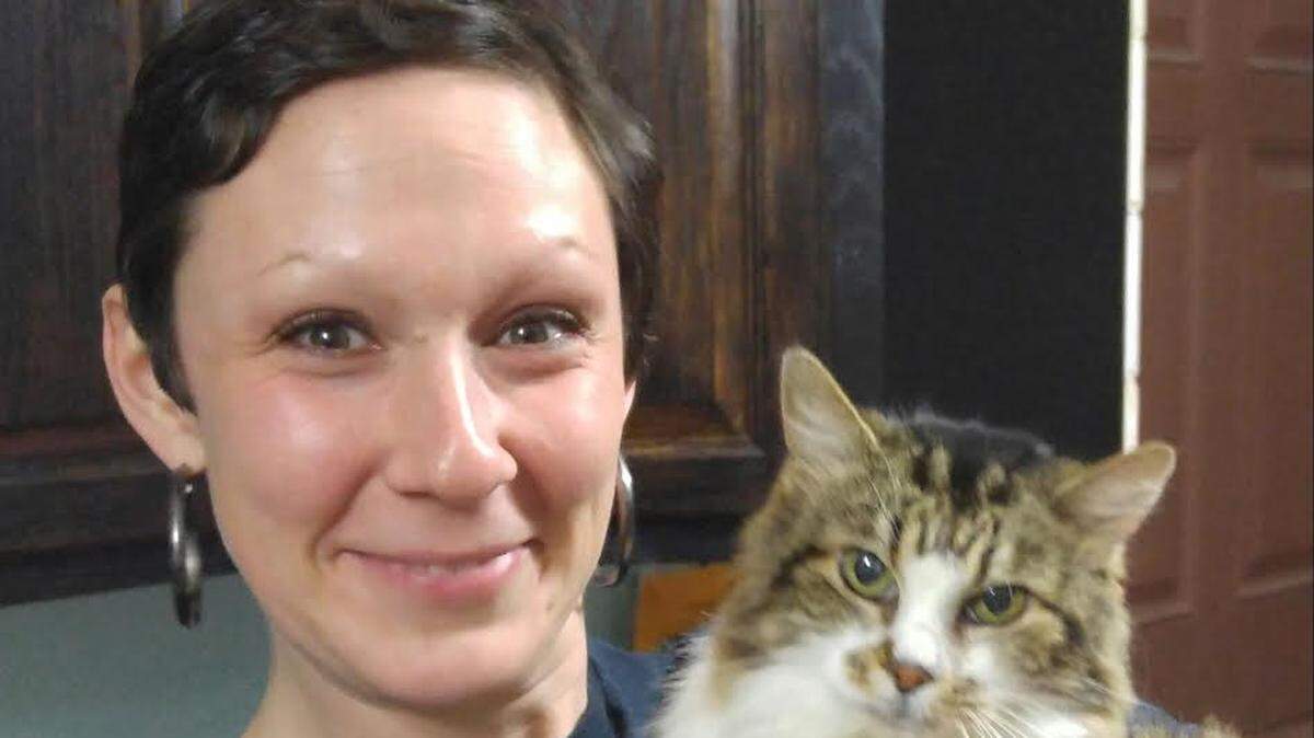 PHOTO COURTESY LIZ GLANTZ 
 Liz Glantz of Saucier shows off her new friend Millie, a 15-year-old cat that Glantz says is an exact replica of former pet.