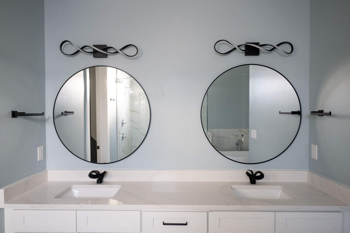 A dual sink and mirror in the master bathroom of a five-bedroom house with five full baths in the new Cristiano Boardwalk subdivision south of U.S. 90 in Biloxi on Tuesday, February. 3, 2026. The home features contemporary fixtures throughout.