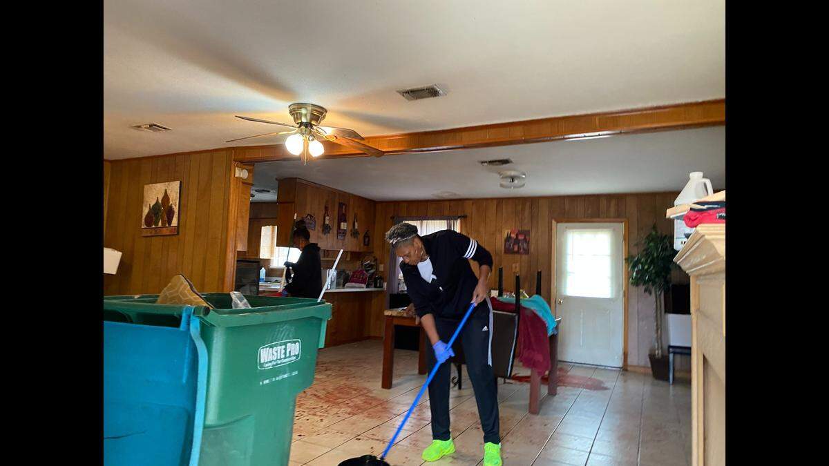 The family of D’quarius Eckford clean up blood in her home after she was repeatedly stabbed by her estranged boyfriend, Jonathan Turner, prior to police shooting and killing him in February 2021.