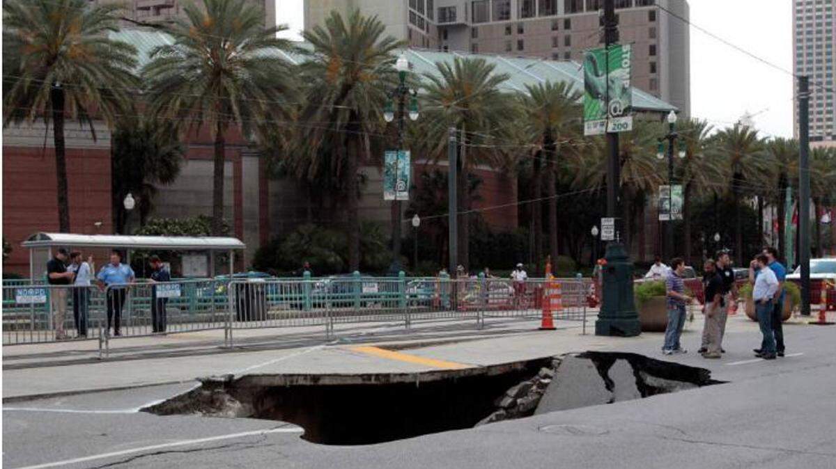 SHERRI MILLER/NEW ORLEANS ADVOCATE 
 A large sinkhole appeared Friday afternoon on Canal Street near Harrah's Casino in New Orleans.
