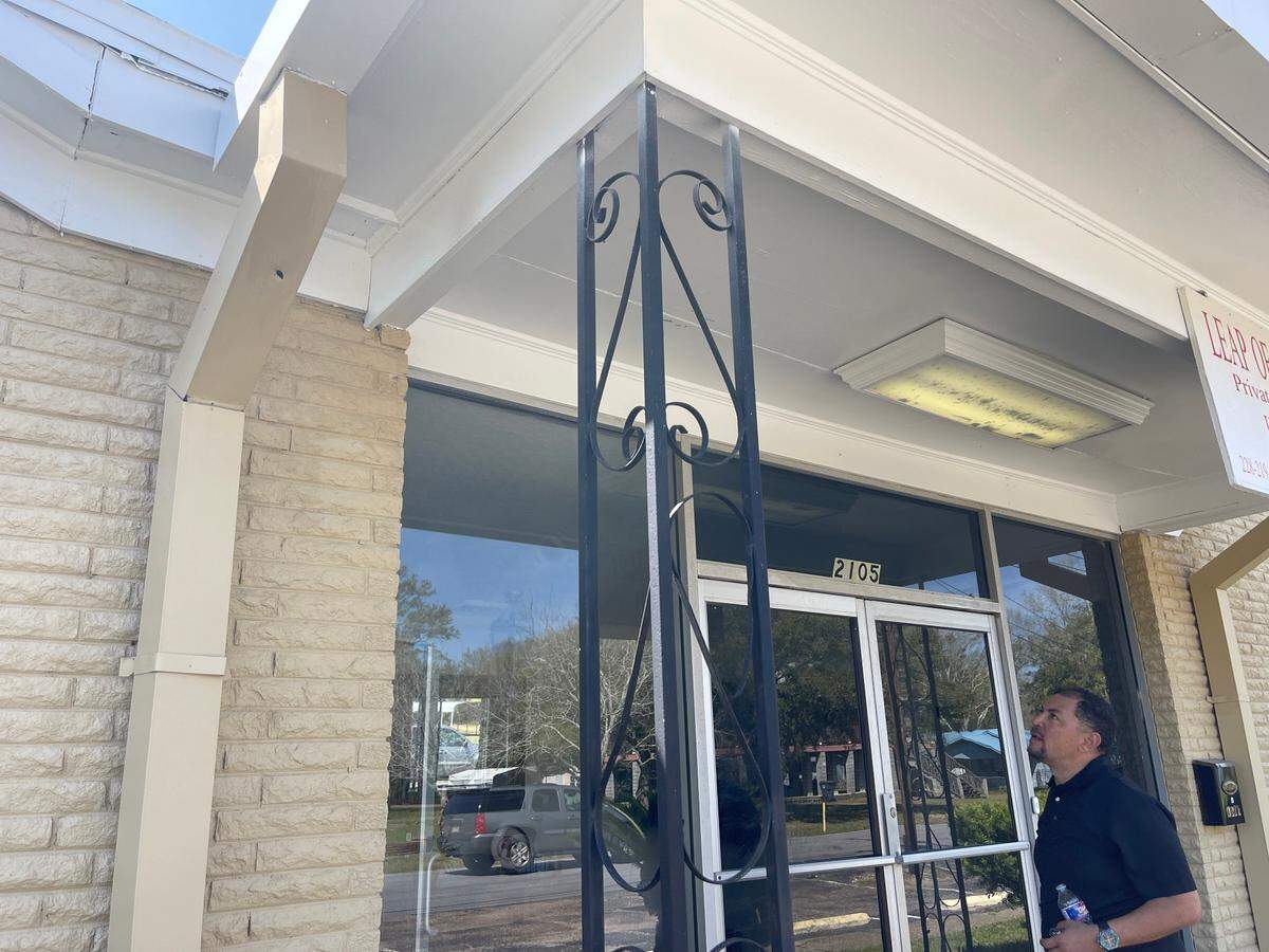 Gustavo Santos Sr. looks toward bullet holes at Leap of Faith private school in Pascagoula on Monday, March 21, 2022.