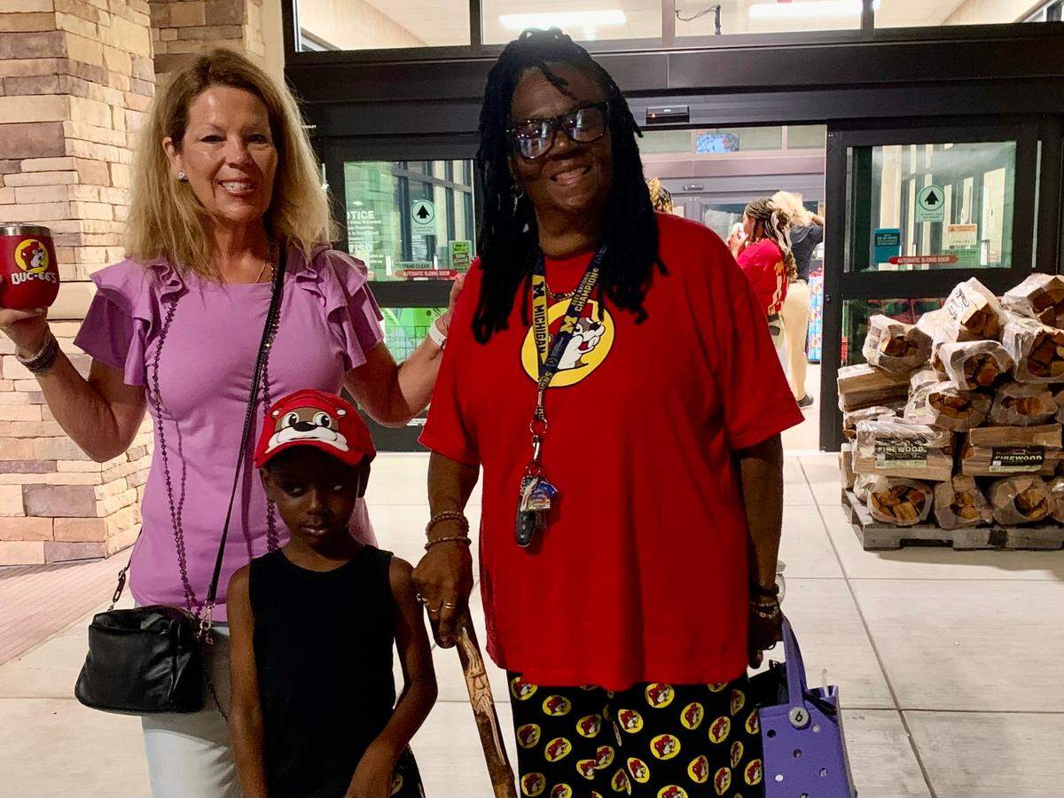 Angela Funk-Wall (from left), Adroiyon Odem Jr. and his great-grandmother Patricia Peoples were among the first on the scene Monday for the opening of Buc-ee’s.