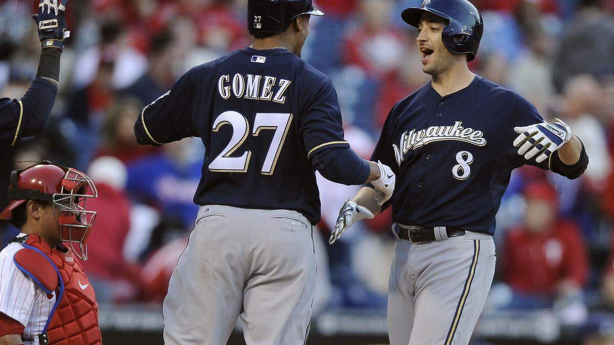 MICHAEL PEREZ 
 Milwaukee Brewers' Ryan Braun (8) scores on his three-run home run and celebrates with Carlos Gomez in the eighth inning of a baseball game against the Philadelphia Phillies on Tuesday, April 8, 2014, in Philadelphia. The Brewers won 10-4. (AP Photo/Michael Perez)