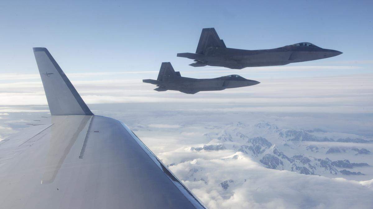 TED S. WARREN/ASSOCIATED PRESS/2010U.S.-built NORAD F-22 fighter jets fly past the wing of a commercial airline over a mountainous area of Alaska.