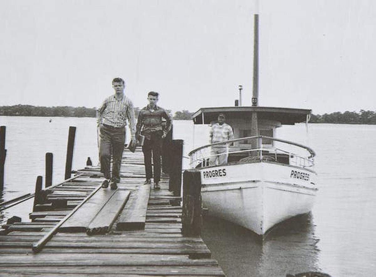 Arthur Baker (right) drops off his sons Alvin (left) and Ronald on a pier near Deer Island as they make their way to school in Biloxi. The family lived on the island off the Biloxi coast for four generations, until Hurricane Camille destroyed their home in 1969.