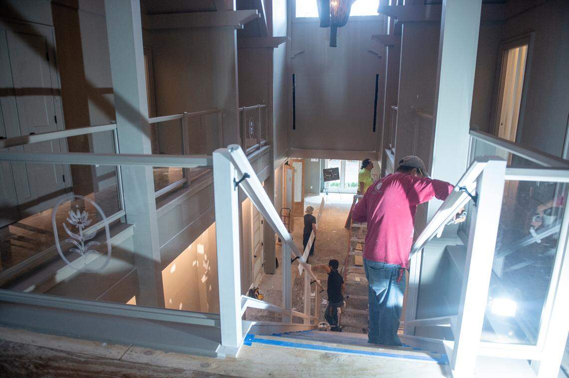 Workers work on the main stairwell of The Springs Hotel while it’s under construction in Ocean Springs on Monday, Nov. 20, 2023.