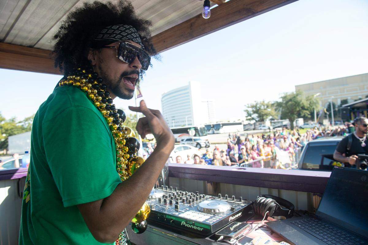 A DJ hypes up the crowd from a float during the Gulf Coast Carnival Association Mardi Gras parade in Biloxi on Tuesday, Feb. 21, 2023.