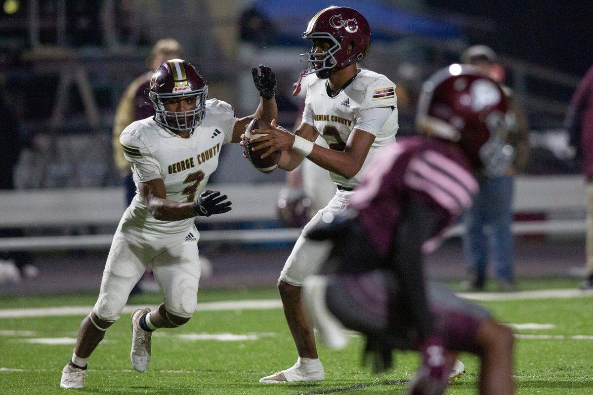 George County’s Deuce Knight hands off a pass to Branden Gautier during a playoff game between Picayune and George County at Lee-Triplett Stadium in Picayune on Friday, Nov. 22, 2024.