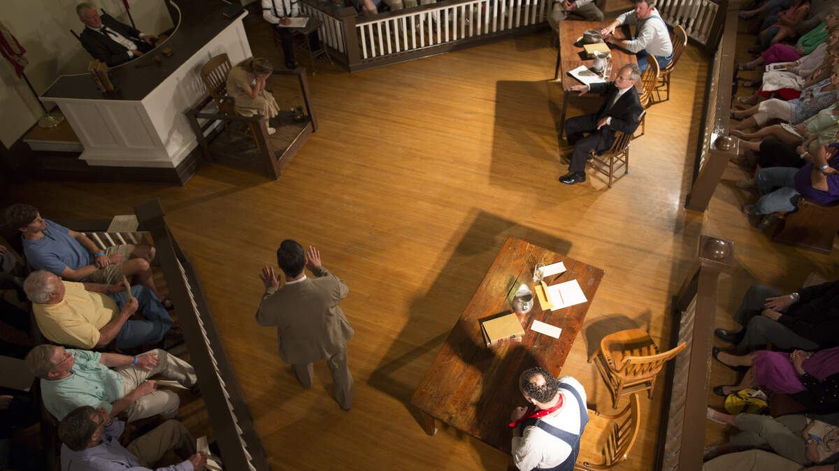 Spectators and jurors selected from the audience surround the performers inside the courthouse during a performance of "To Kill a Mockingbird" in Monroeville, Ala., April 11, 2015. Each April and May for 26 years, local amateurs in Harper Lee's hometown have put on the Christopher Sergel stage adaptation of the novel "To Kill a Mockingbird," using the courthouse where Lee's father once practiced law for the court scenes. (Jeff Haller/The New York Times)