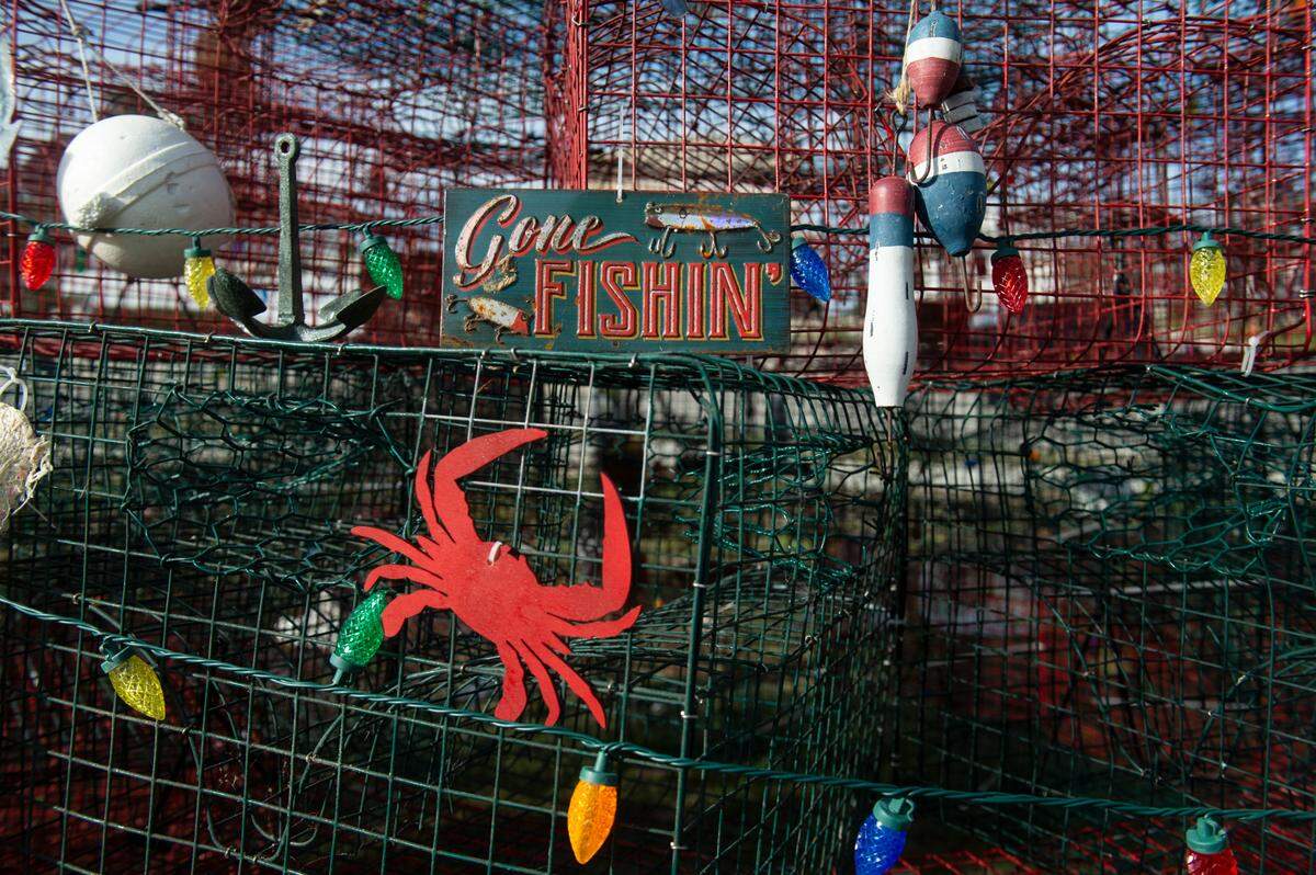Small details like fishing signs and lights hang on a Christmas tree made out of crab traps and other fishing equipment at the Pass Christian Harbor on Thursday, Nov. 30, 2023.