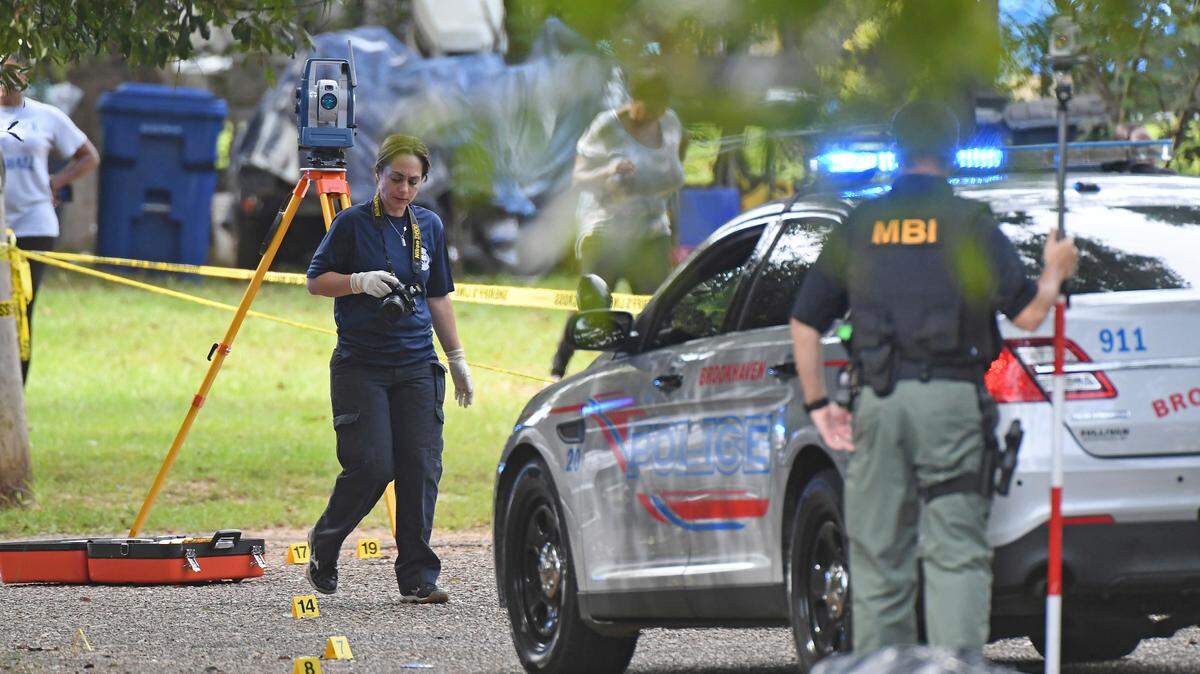 Mississippi Bureau of Investigations officers photograph the scene where two Brookhaven Police Officers were shot and killed Saturday.