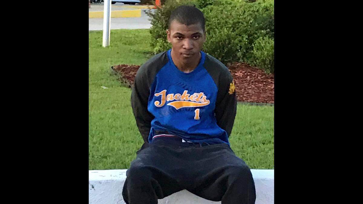 Davian Atkinson wears a St. Martin High School shirt after his arrest in Stone County. Atkinson did not attend St. Martin, he is a Biloxi High School graduate. His brother, Wanya Atkinson, is accused of providing him a change of clothes after the fatal shooting of officer Robert McKeithen.