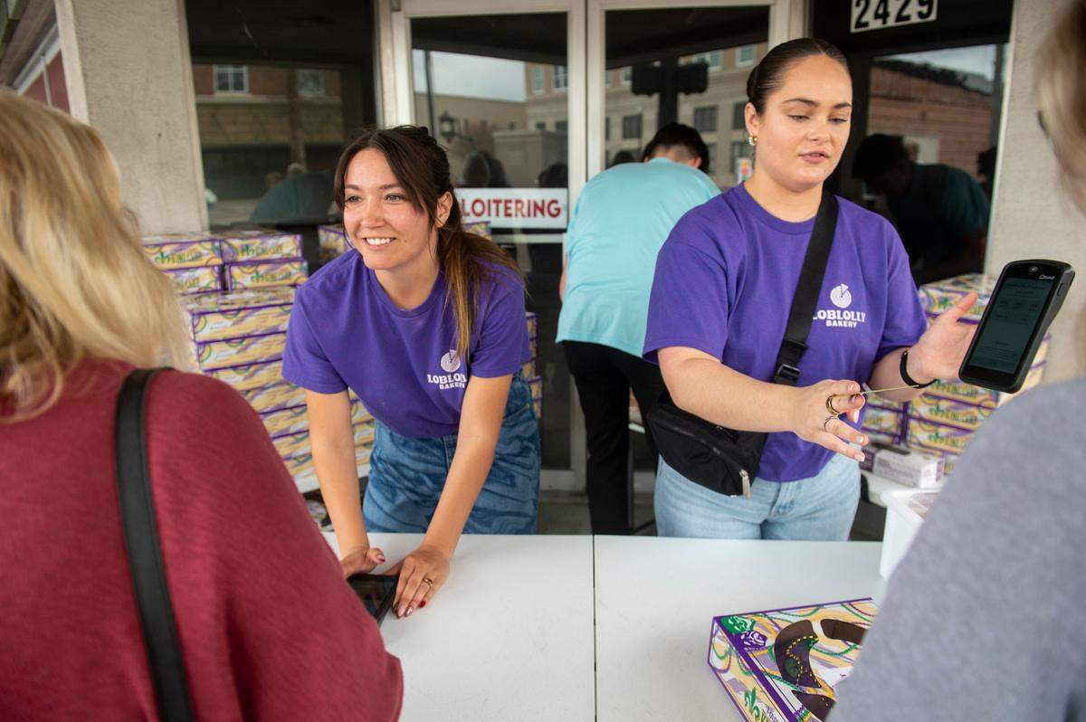 Camren Hensarling and Paige Brennan sell Loblolly Bakery king cakes during a pop-up sale in Gulfport on Friday, Feb. 7, 2025.