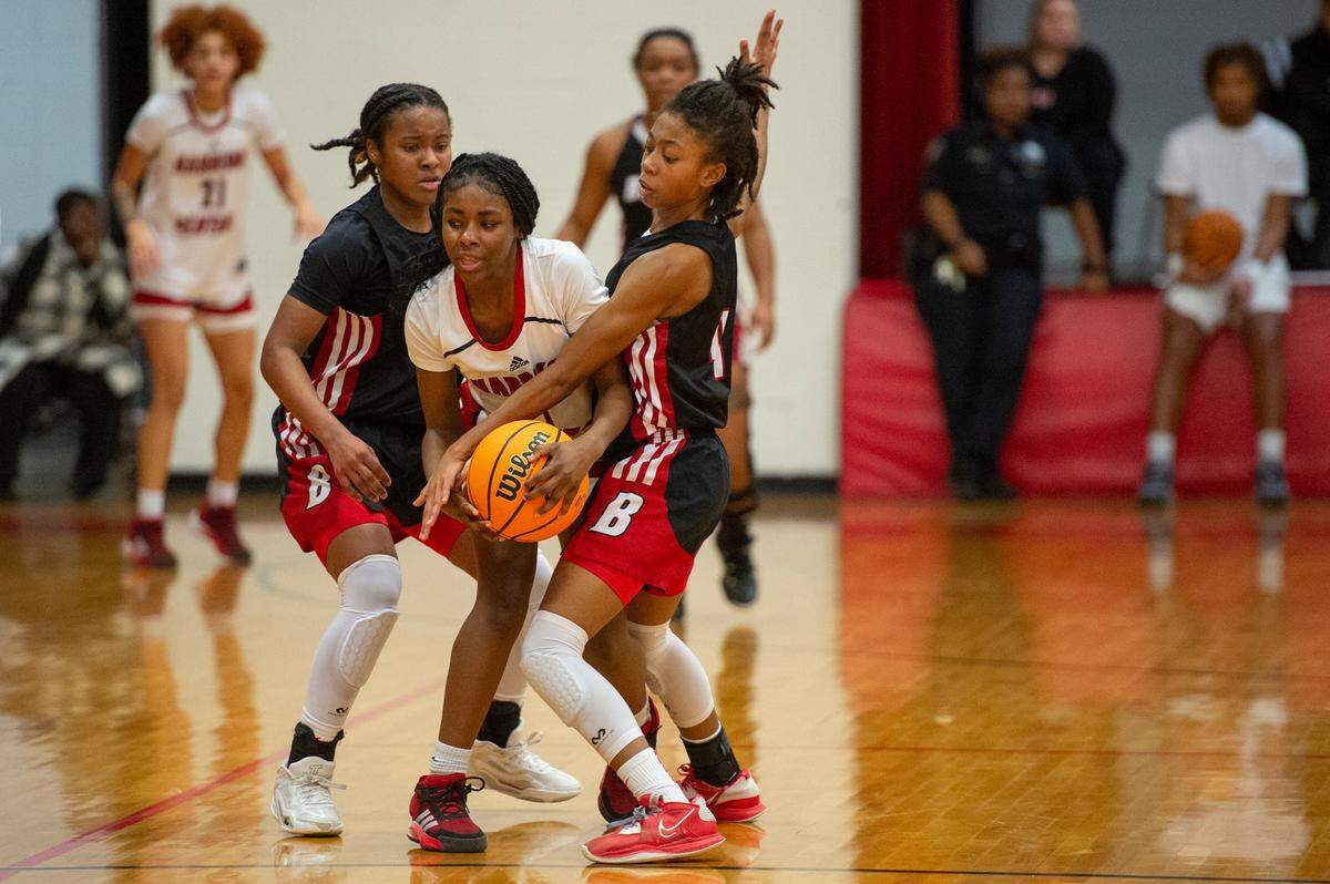 Biloxi’s Aaliyah Davison and Amari Merideth play defense on Harrison Central’s Michelle Jackson during a game against Harrison Central at Harrison Central High School in Harrison County on Tuesday, Dec. 12, 2023.