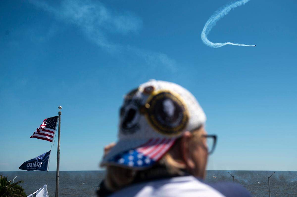 Fans of the U.S. Air Force Thunderbirds watch them from the roof of the White House Hotel during a practice for the Thunder Over the Sound airshow on Friday, April 28, 2023.