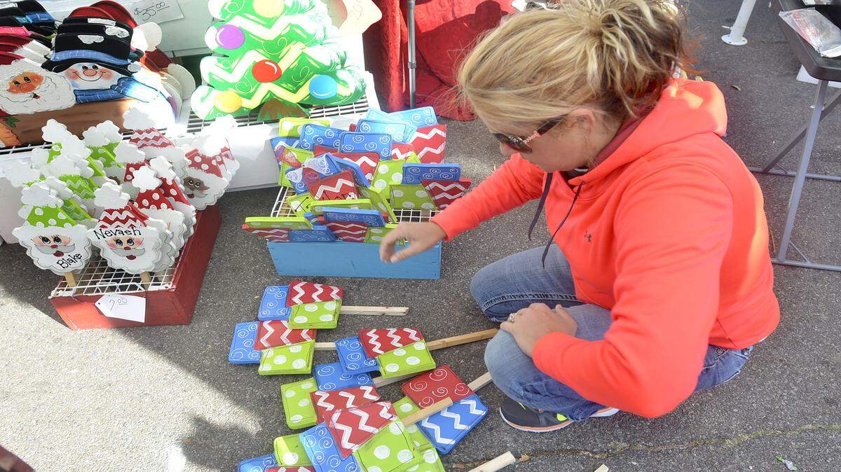 TIM ISBELL/SUN HERALDKristy Gowers gathers Christmas crafts to personalize at the 2014 Peter Anderson Festival in downtown Ocean Springs.