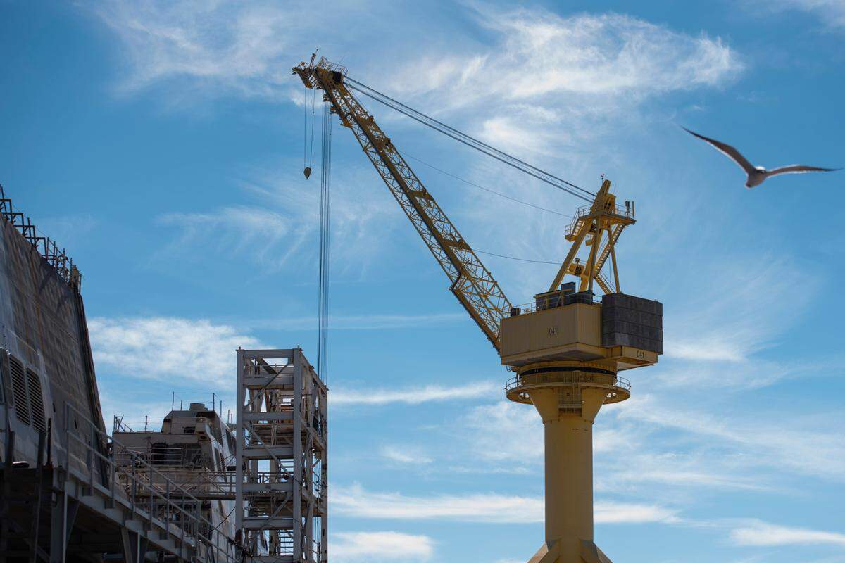 A crane towers over the shipyard at Ingalls Shipbuilding in Pascagoula on Wednesday, Jan. 26, 2022.