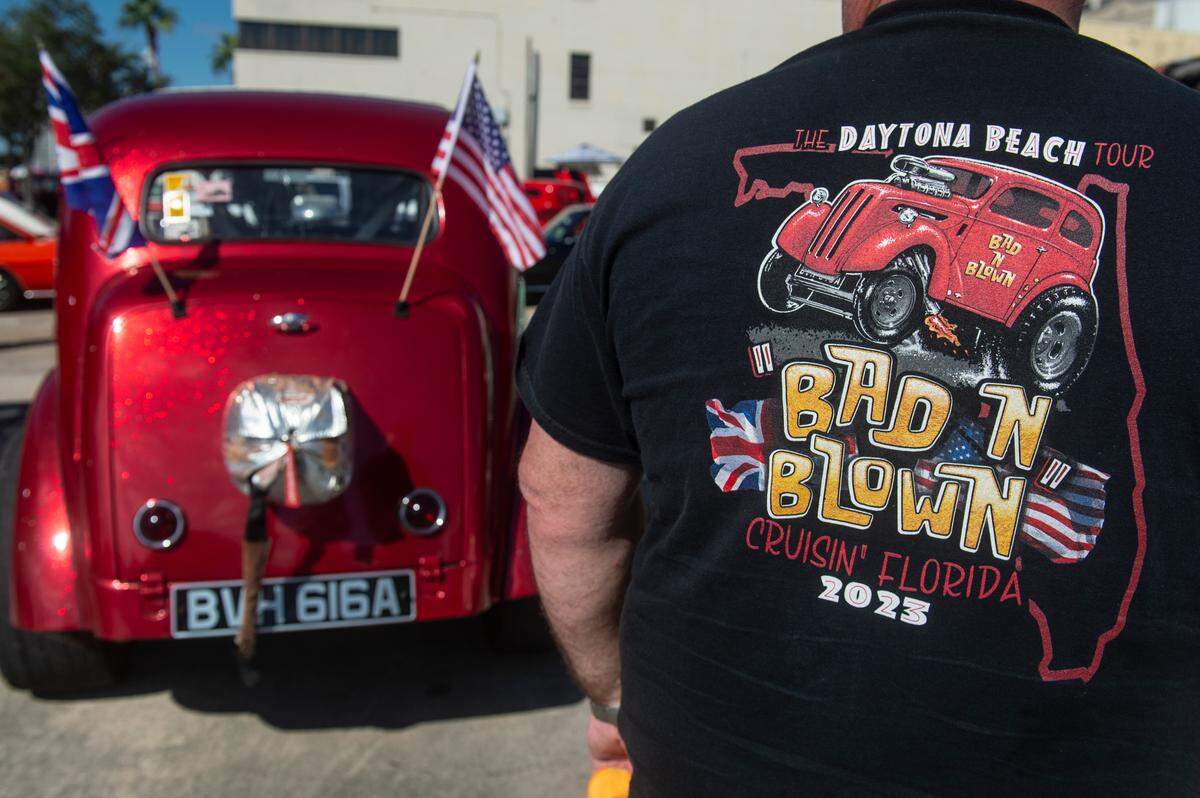 Martin Bishop wears a t-shirt with the name of his 1952 Ford Anglia as he stands in front of it during View the Cruise at Cruisin’ The Coast in Gulfport on Sunday, Oct. 6, 2024.