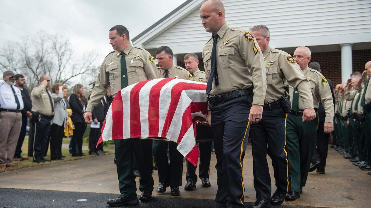 Members of law enforcement carry the casket of George County Sheriff’s Deputy Jeremy Malone following Malone’s funeral Friday at Agricola Baptist Church. Malone was shot and killed while conducting a traffic stop on Jan. 4.
