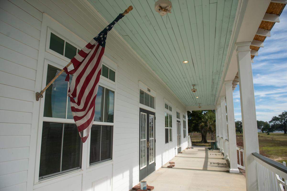 A torn flag hangs outside the former clubhouse of Great Southern Golf Club on Wednesday, Nov. 9, 2022. The club, which closed in May, is supposed to be developed into housing developments but neighbors are concerned about the environmental impact.