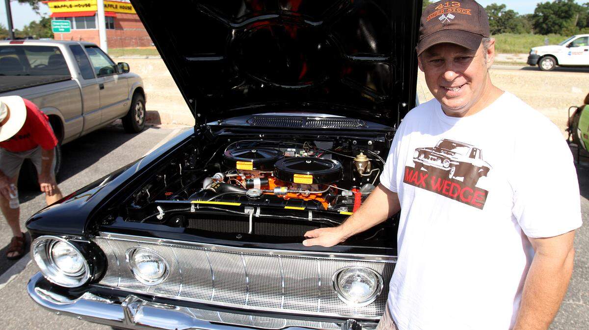 AMANDA McCOY/SUN HERALDJeff Prusinowski of Biloxi stands beside his 1962 Plymouth Savoy on Thursday in Long Beach.
