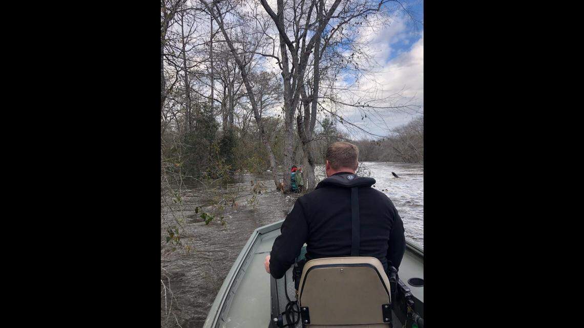 Two Georgia kayakers were saved Sunday after a current flipped them from their boats on the Ohoopee River. Both were wearing life vests and clung to a tree until help arrived.