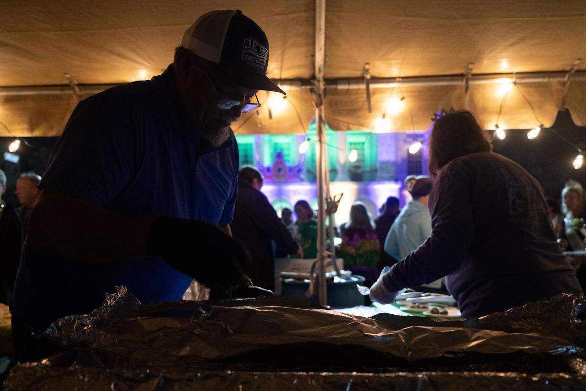 Event volunteers prepare desserts during a 12th Night Celebration in Biloxi on Monday, Jan. 5, 2026.