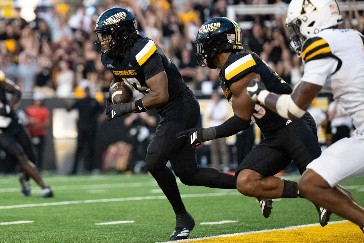 Southern Miss linebacker Mathis Haygood (13) brings the ball out of the end zone after getting an interception during a football game at M. M. Roberts Stadium on Saturday, Sept. 13, 2025.