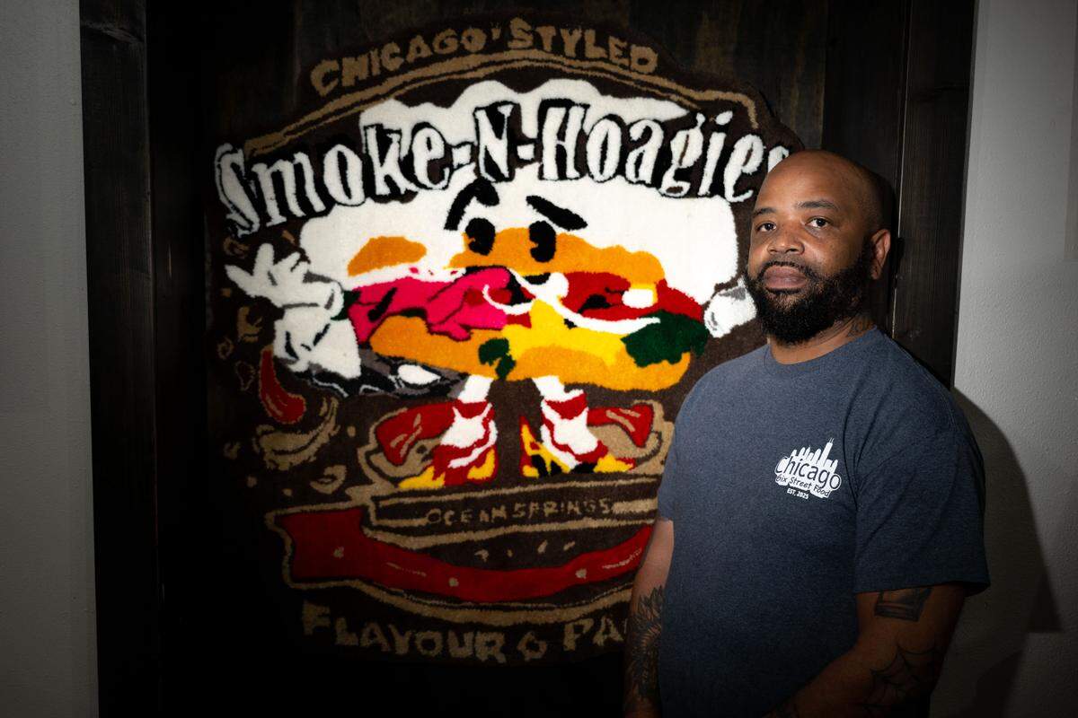 Erik Robinson poses for a portrait in front of a sign at Chicago 6ix on 1224 Bienville Boulevard on Tuesday, May 5, 2026. The restaurant that began as Smoke-N-Hoagies now is Chicago 6ix at a prime location.