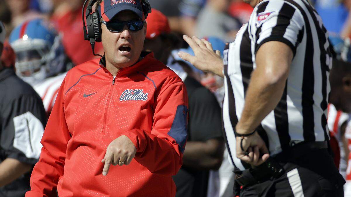 MARK HUMPHREY/ASSOCIATED PRESS 
 Ole Miss head coach Hugh Freeze, left, argues a call Saturday in Memphis, Tenn. Memphis upset No. 13 Ole Miss 37-24.
