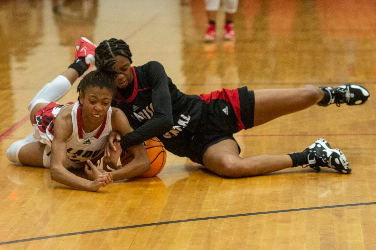 Biloxi’s Aaliyah Davison and Harrison Central’s Anaisha Carriere fight for the ball during the district title game at Harrison Central High School in Gulfport on Friday, Feb. 10, 2023.