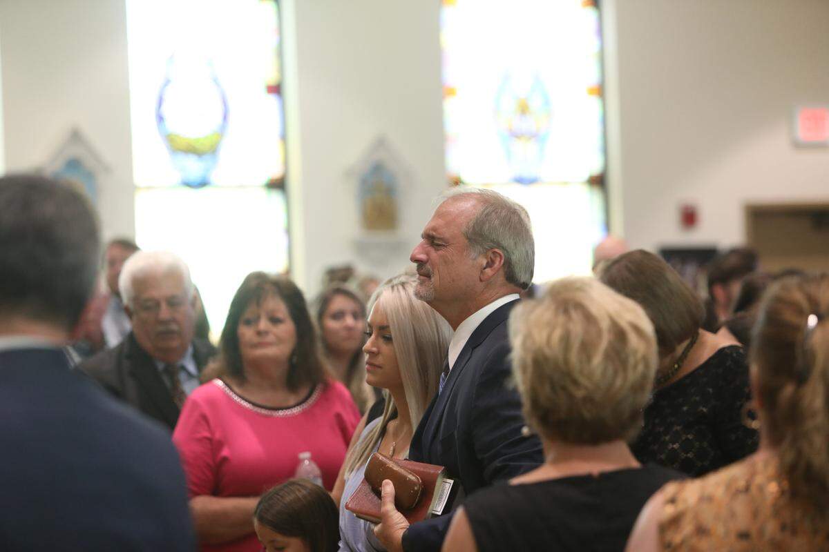 Doug Seal cries as his son, Cayce Seal, is led out of St. Clare Catholic Church in Waveland on July 1, 2021. Cayce Seal, 28, died last week after suffering an electric shock while working on power lines. Cayce’s girlfriend, Cassie Lassabe, walked next to Doug Seal.