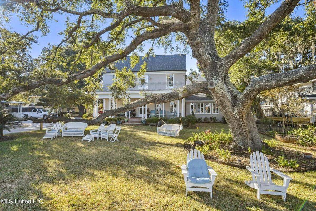 A stately oak casts shade over the front yard of 600 N. Beach Boulevard’s estate.