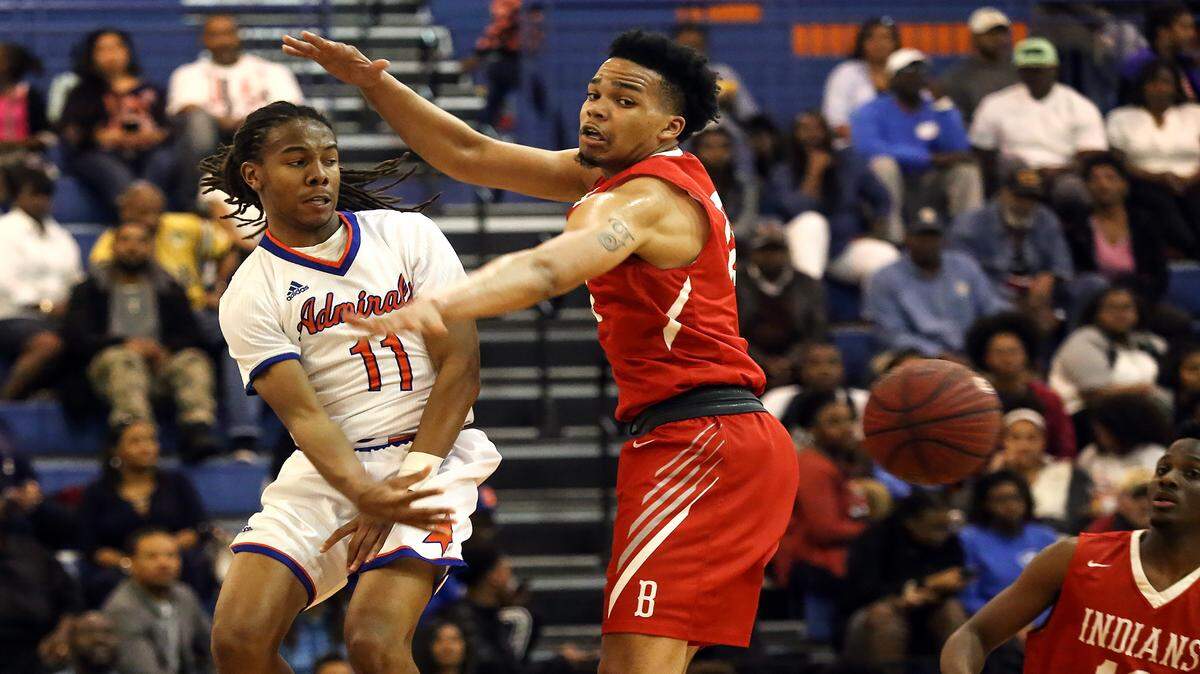 AMANDA McCOY/SUN HERALD 
 Gulfport's Tyrell McArthur makes a quick pass around Biloxi's Fred Ramsey-Thompson on Friday, Feb. 12, 2016, at Gulfport High.