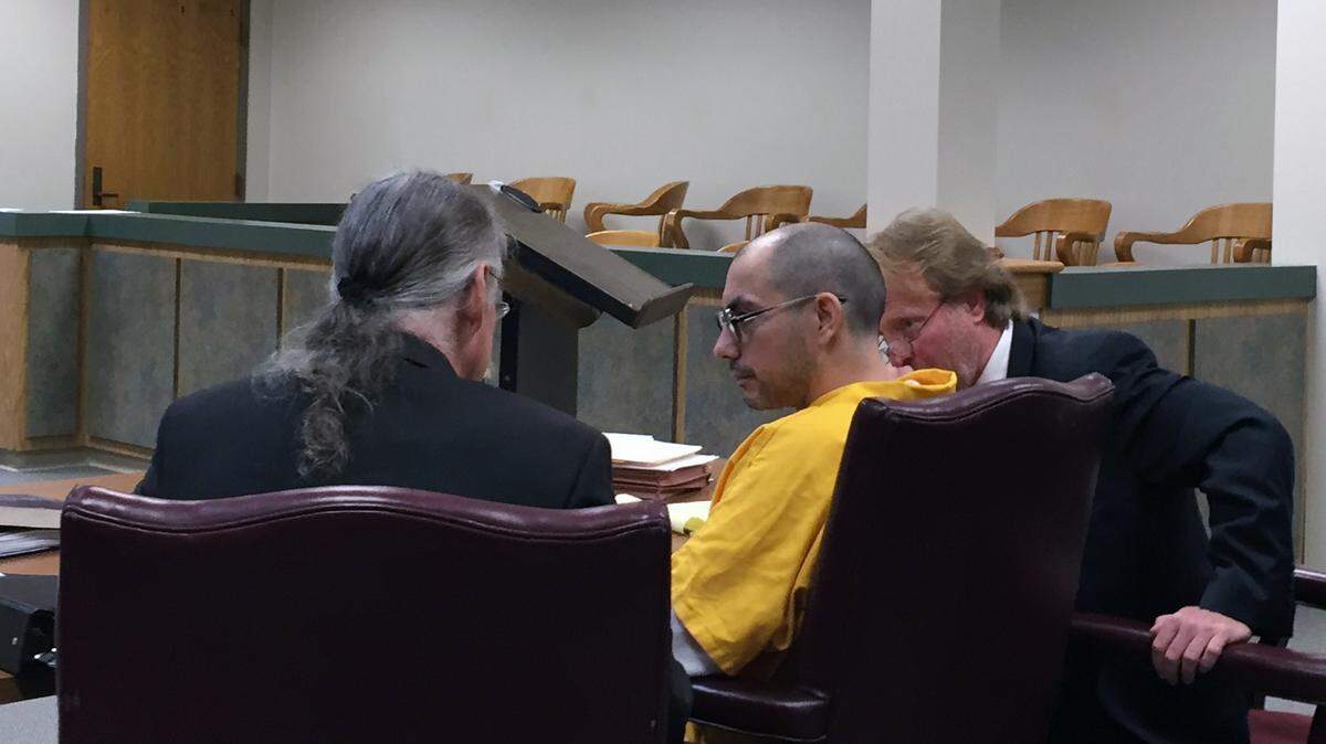 MARGARET BAKER/SUN HERALD 
 Stephen McGilberry confers with his attorneys Thursday in Jackson County Circuit Court. He was there to schedule his second resentencing for killing his family at age 16.