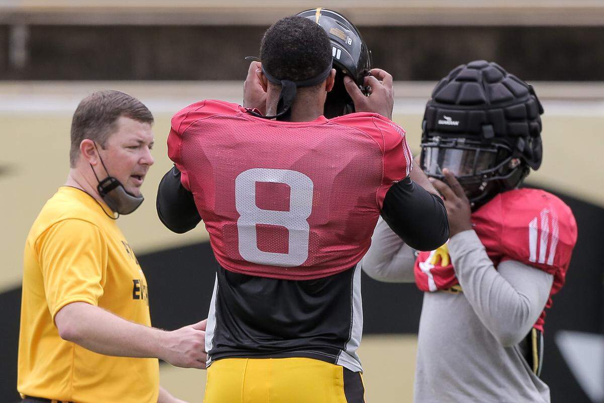 Southern Miss head coach Will Hall speaks with quarterback Trey Lowe (8) and running back Frank Gore, Jr., during practice on Saturday, February 27, 2021 at M.M. Roberts Stadium in Hattiesburg.